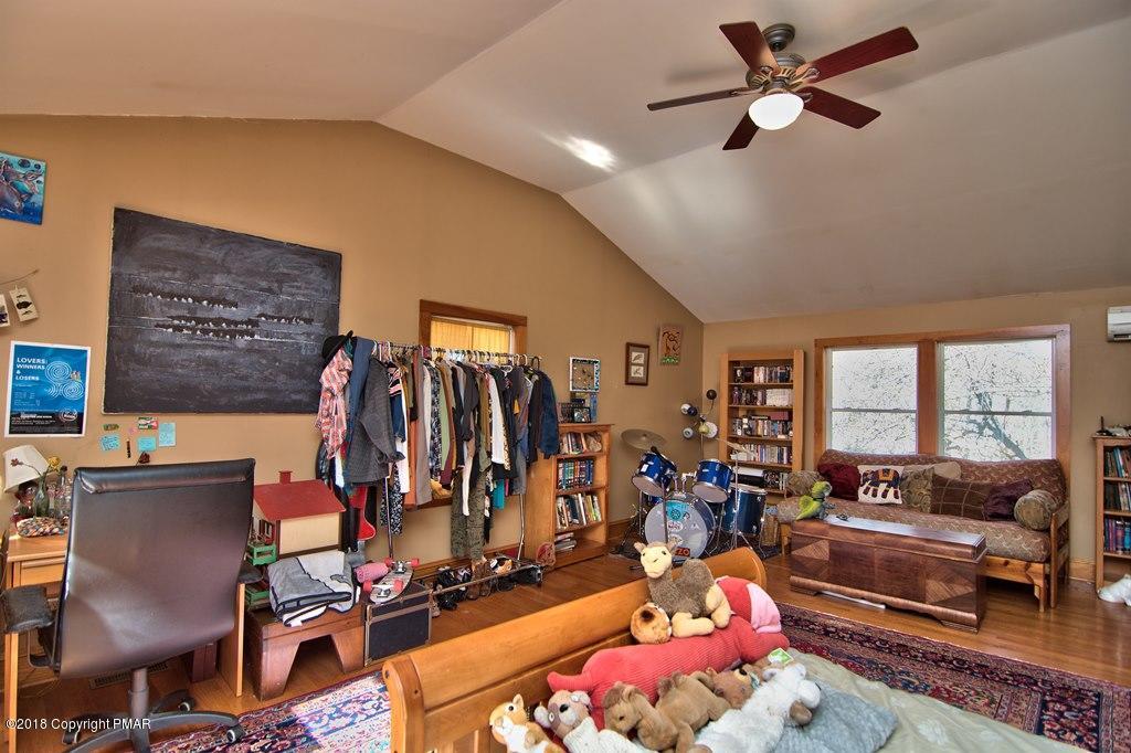 465 Pensyl Creek Road Stroudsburg, PA 18360 - Photo 34 of 80 a living room with lots of furniture and a flat screen tv
