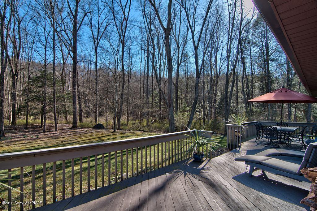 465 Pensyl Creek Road Stroudsburg, PA 18360 - Photo 46 of 80 a balcony with wooden floor table and chairs