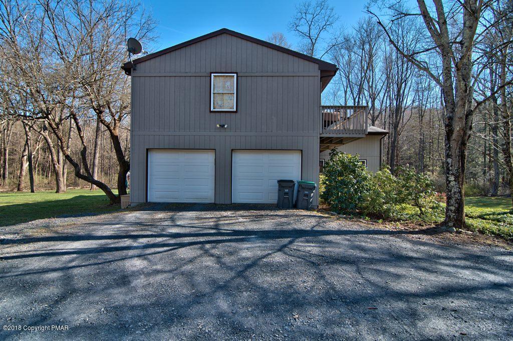 465 Pensyl Creek Road Stroudsburg, PA 18360 - Photo 58 of 80 a front view of a house with a yard and garage
