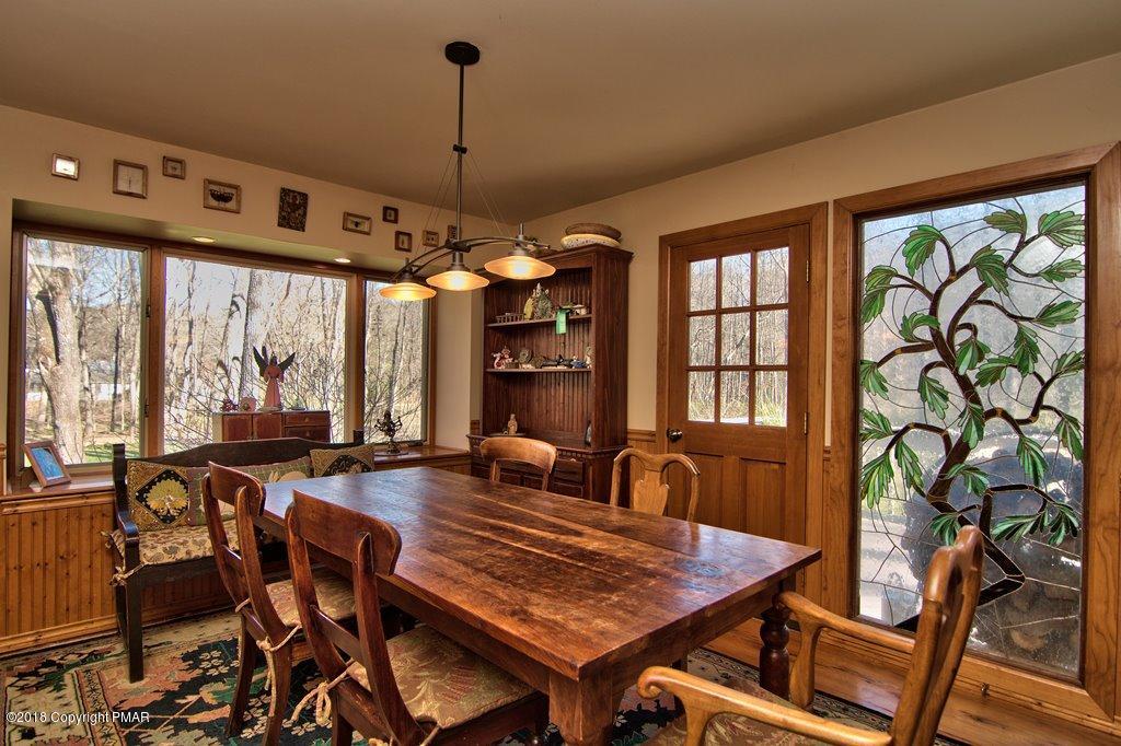 465 Pensyl Creek Road Stroudsburg, PA 18360 - Photo 9 of 80 a view of a dining room with furniture large windows and wooden floor