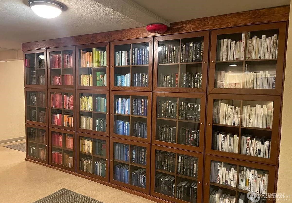 124 Warren Avenue North, Unit 310 Seattle, WA 98109 - Photo 12 of 12 a book shelf in a room with a book shelf