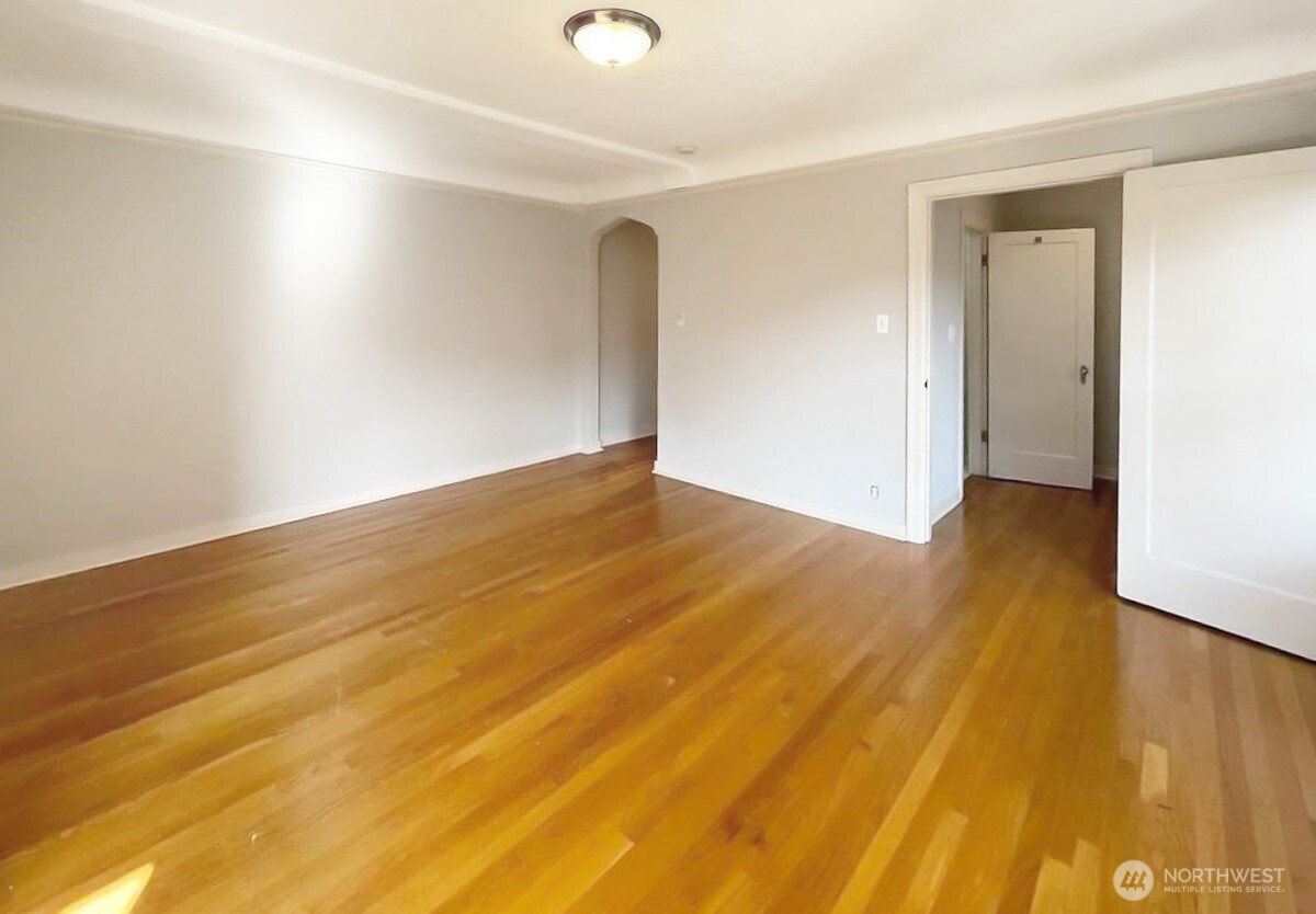 124 Warren Avenue North, Unit 310 Seattle, WA 98109 - Photo 4 of 12 a view of an empty room with wooden floor