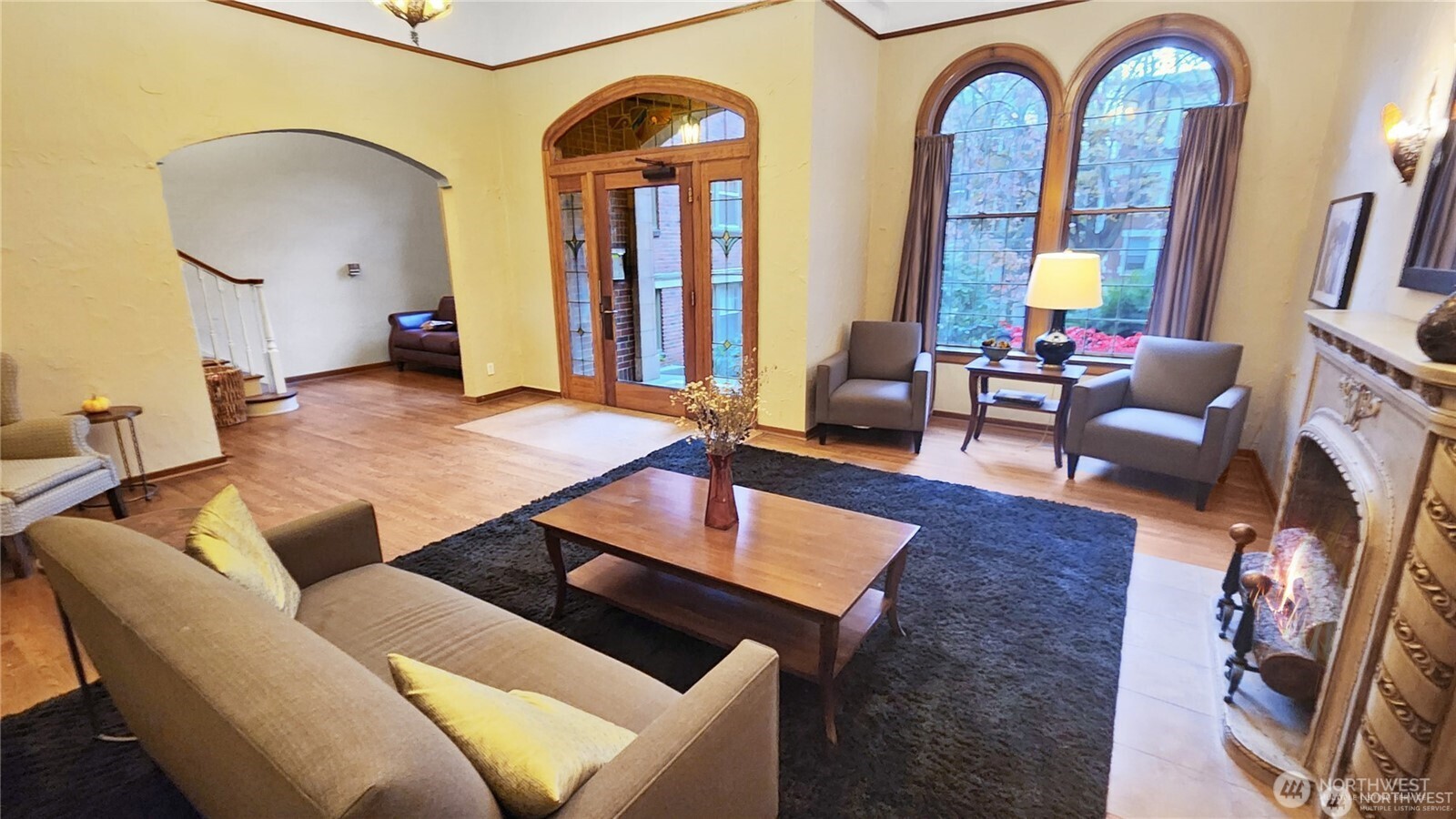 124 Warren Avenue North, Unit 310 Seattle, WA 98109 - Photo 10 of 12 a living room with furniture a fireplace and a table