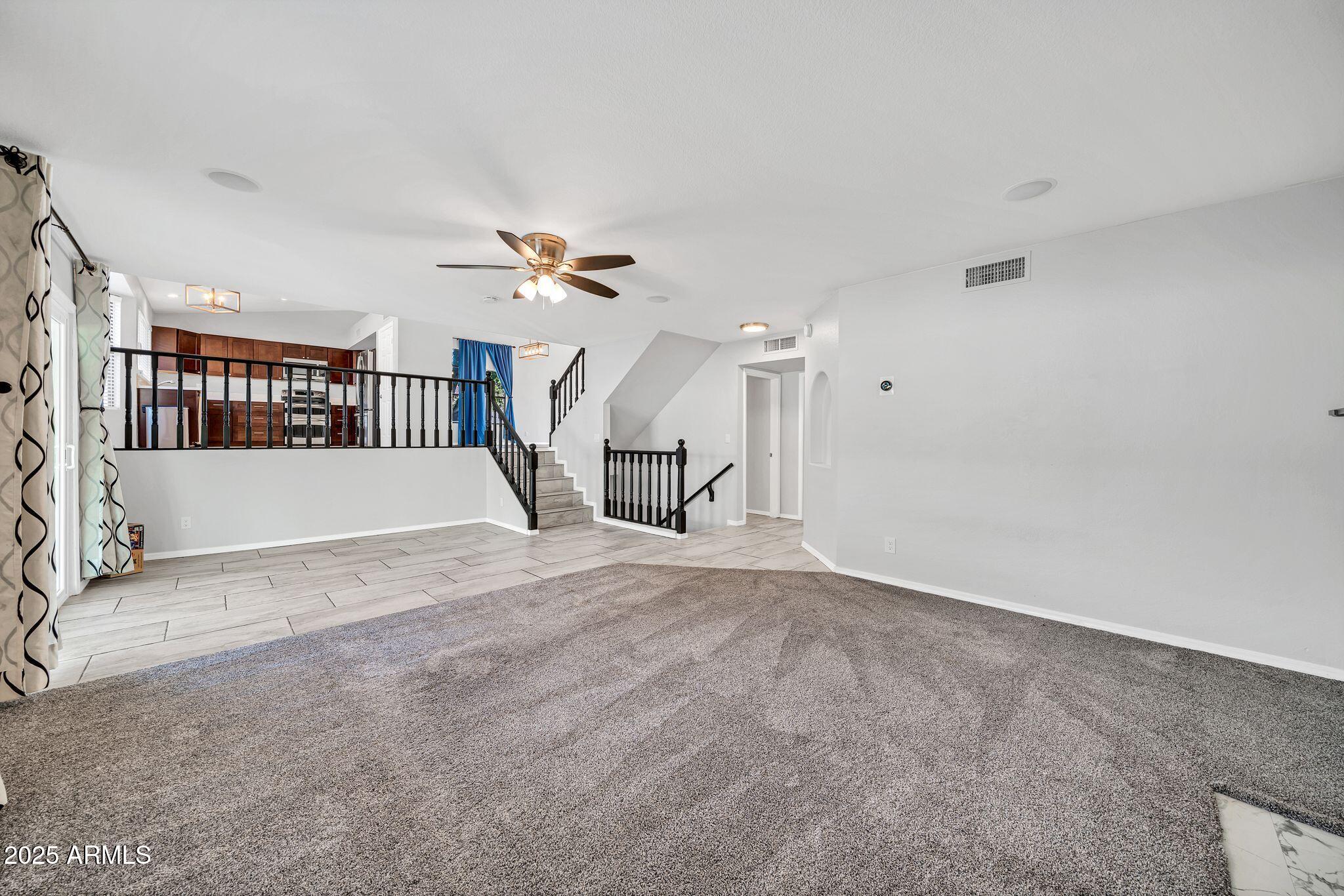 5044 East Paradise Lane Scottsdale, AZ 85254 - Photo 6 of 61 a view of a livingroom with a staircase and white walls
