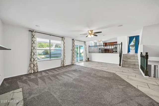 a view of a livingroom with a staircase and white walls