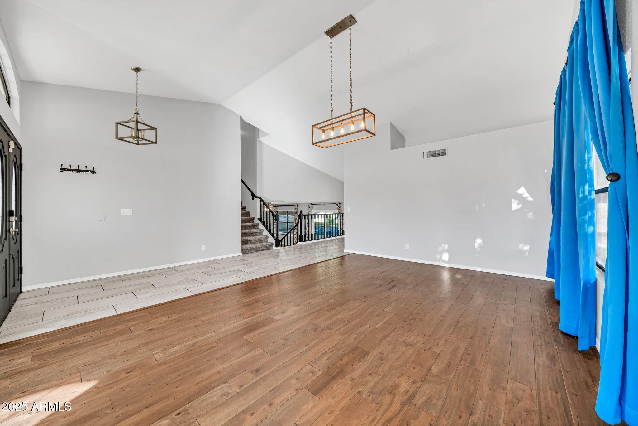 5044 East Paradise Lane Scottsdale, AZ 85254 - Photo 11 of 61 a view of an empty room with wooden floor and a window