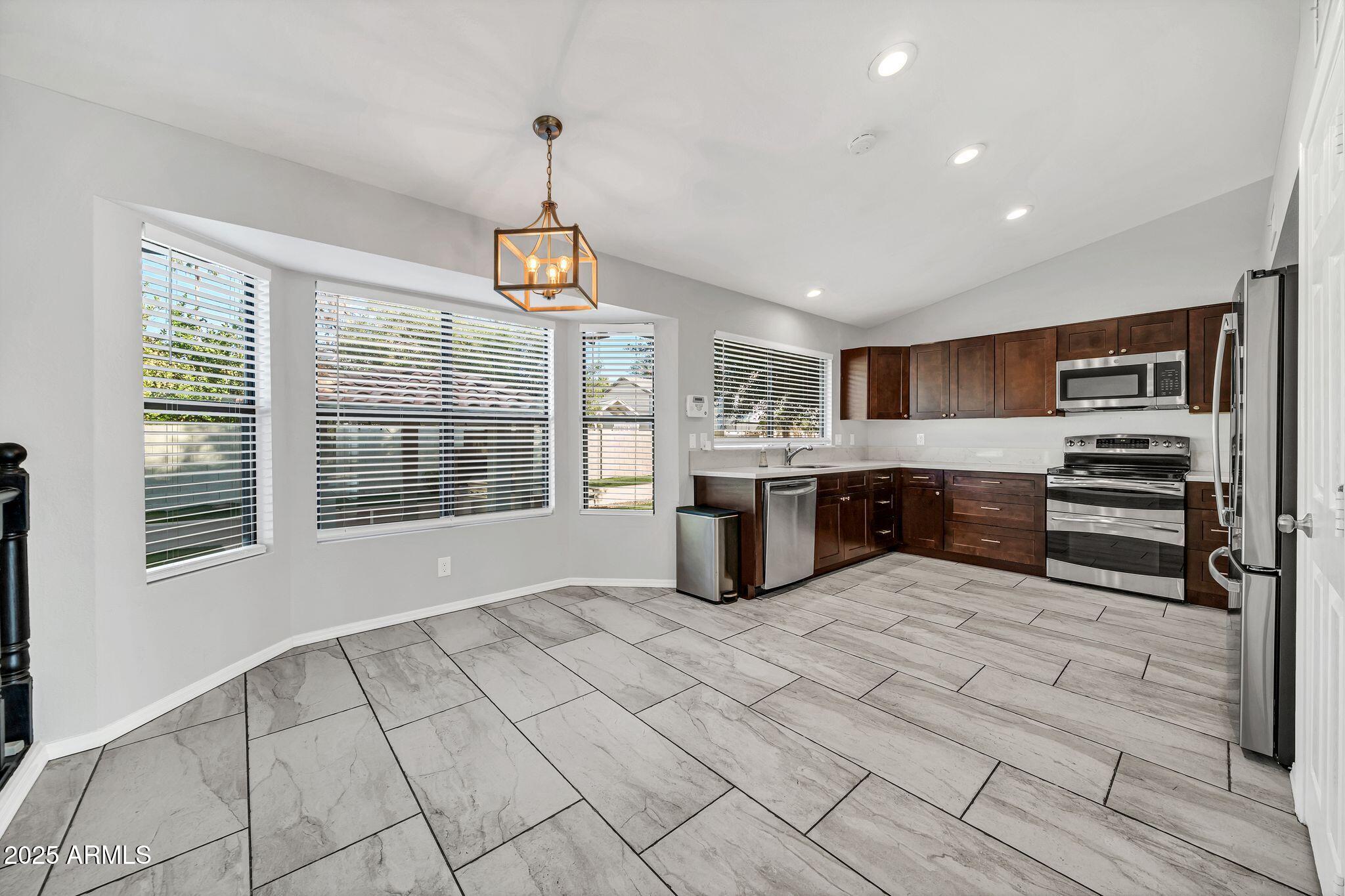 5044 East Paradise Lane Scottsdale, AZ 85254 - Photo 15 of 61 a kitchen with stainless steel appliances granite countertop a stove and a sink