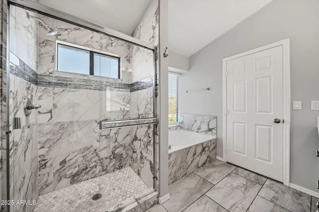 a bathroom with a granite countertop sink a large mirror and a shower