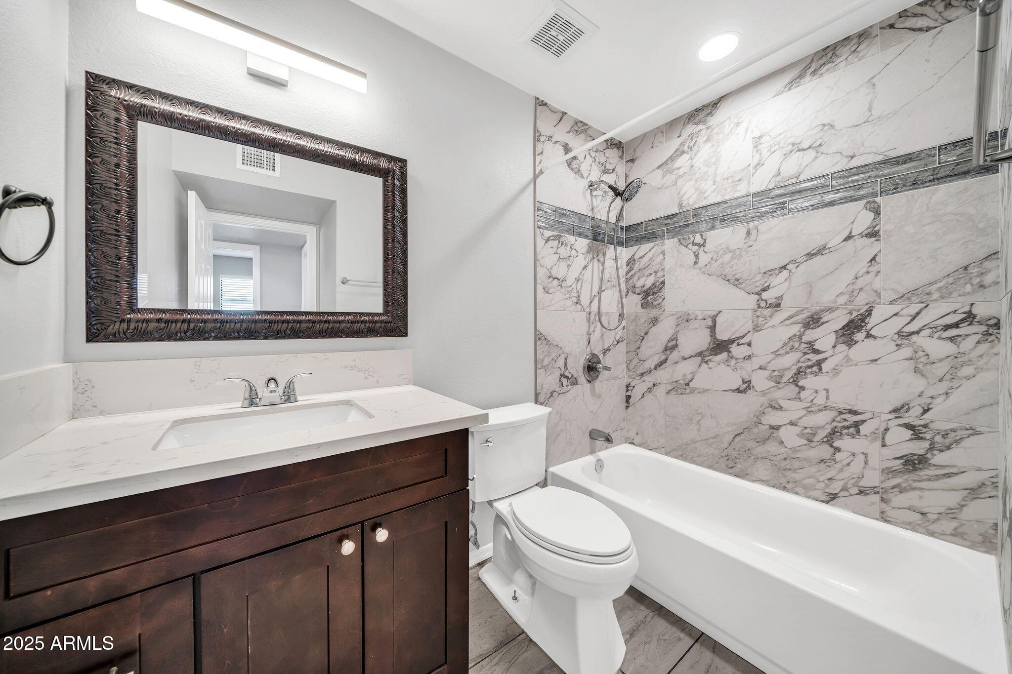 5044 East Paradise Lane Scottsdale, AZ 85254 - Photo 25 of 61 a bathroom with a toilet sink vanity tub and shower