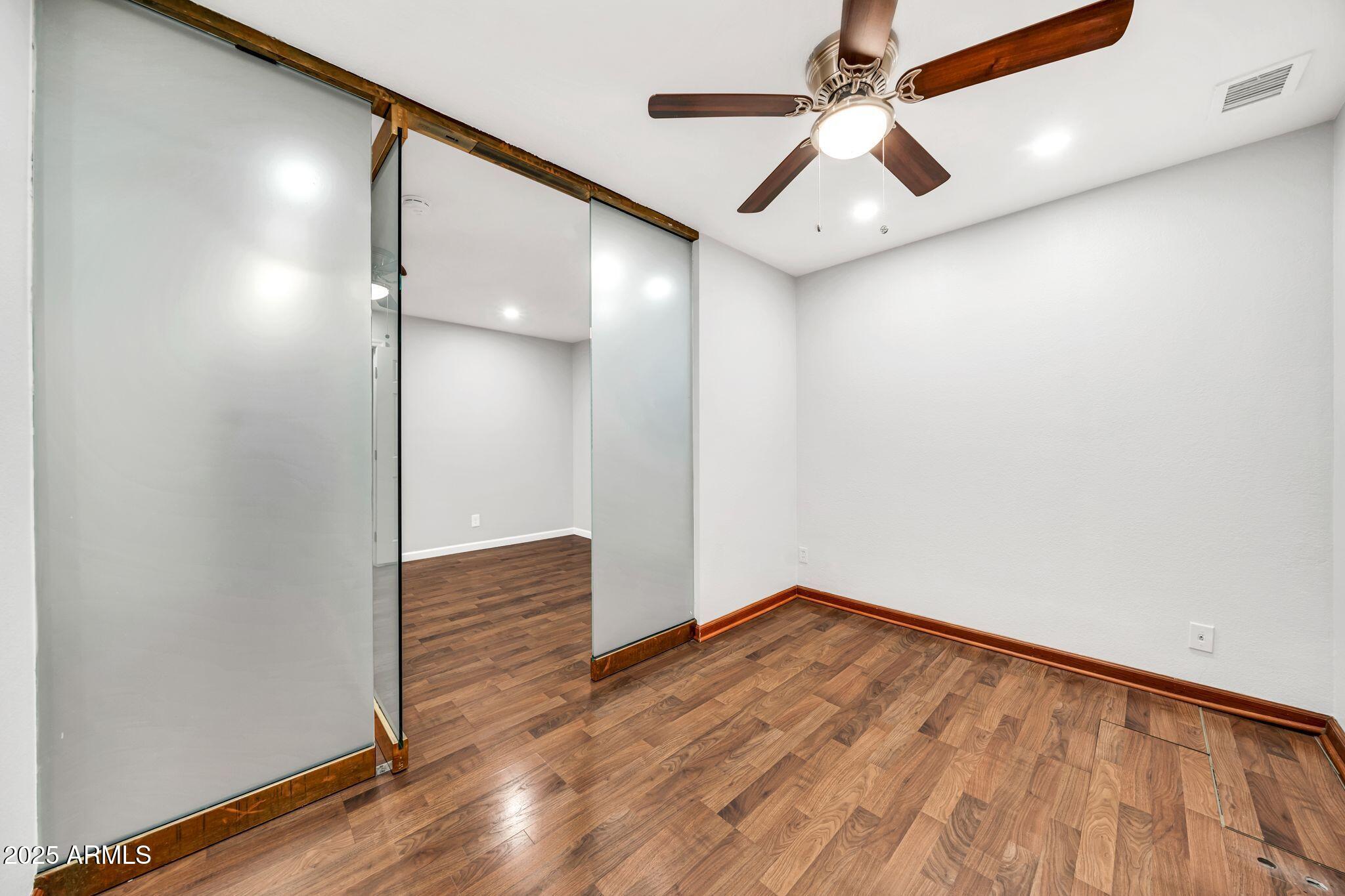 5044 East Paradise Lane Scottsdale, AZ 85254 - Photo 27 of 61 a view of empty room with wooden floor