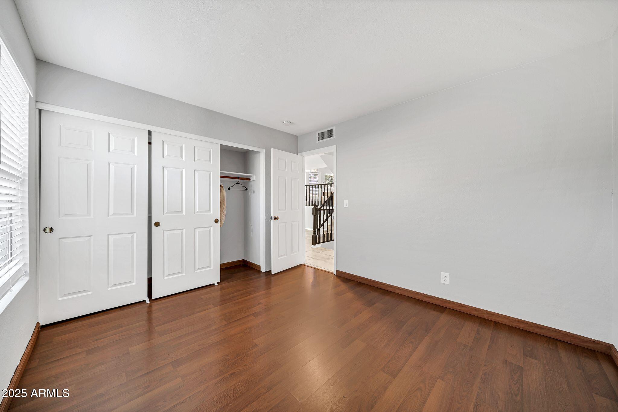 5044 East Paradise Lane Scottsdale, AZ 85254 - Photo 32 of 61 a view of an empty room with wooden floor