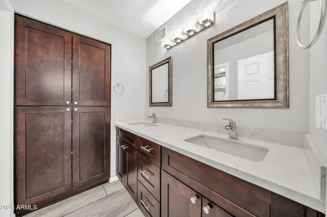 an empty room with wooden floor and a ceiling fan