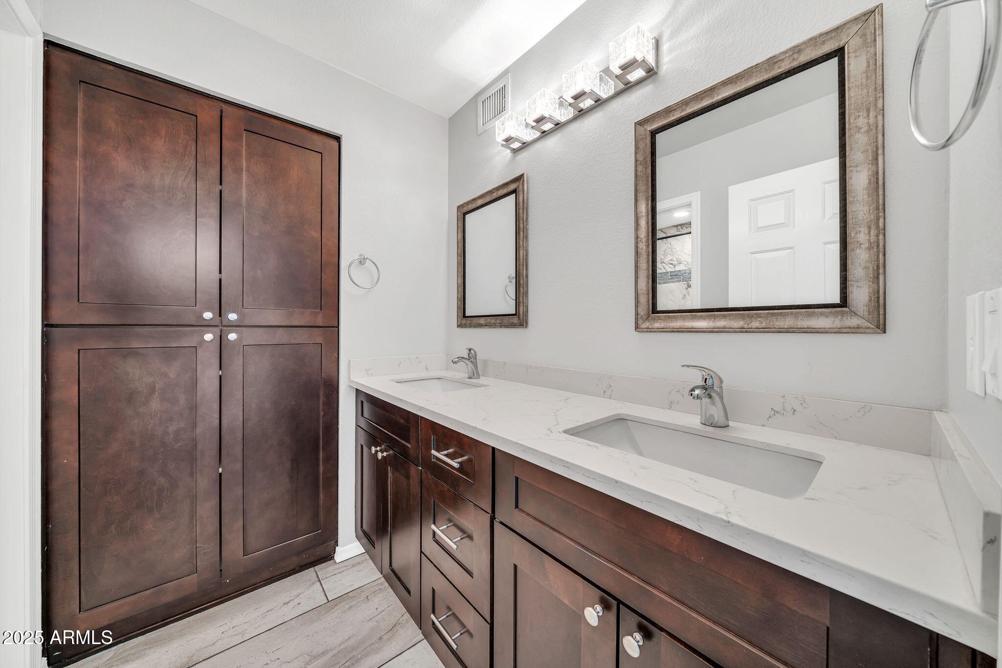 5044 East Paradise Lane Scottsdale, AZ 85254 - Photo 37 of 61 a bathroom with a sink and a mirror