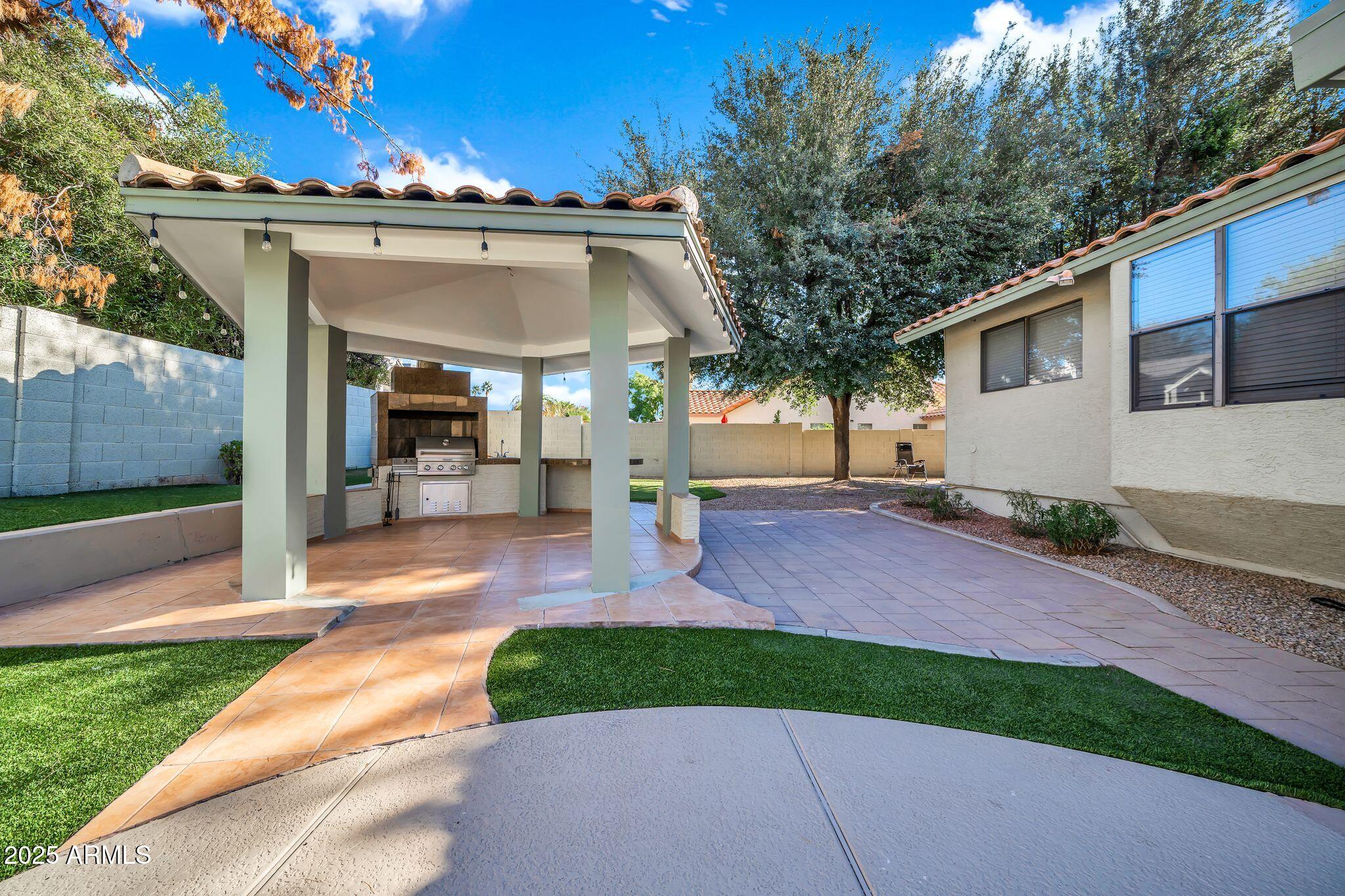 5044 East Paradise Lane Scottsdale, AZ 85254 - Photo 43 of 61 a front view of a house with a yard