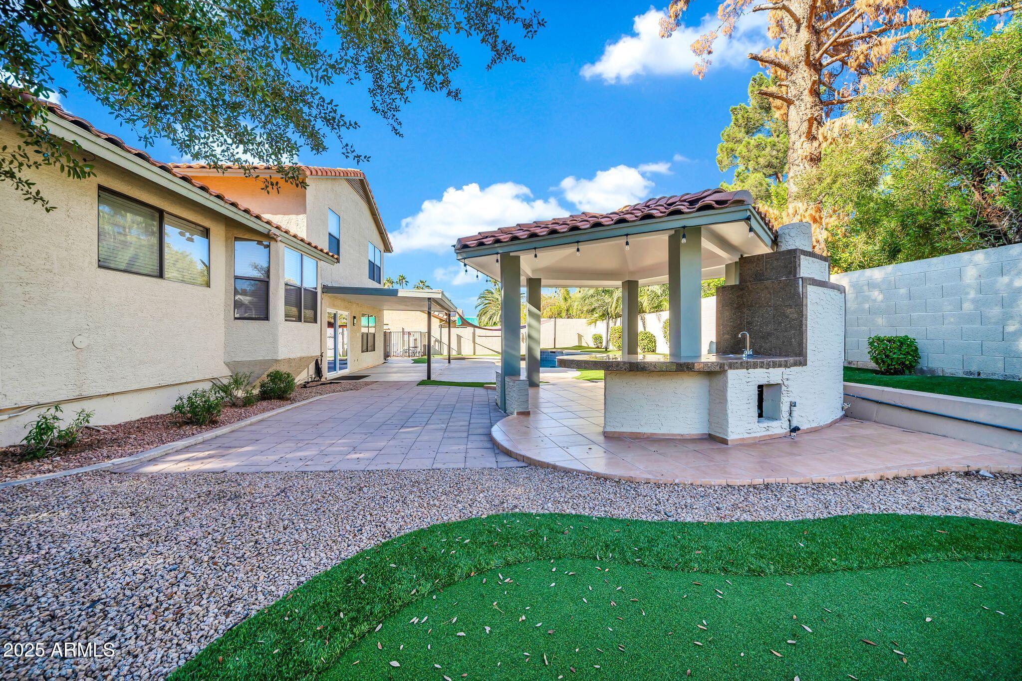 5044 East Paradise Lane Scottsdale, AZ 85254 - Photo 45 of 61 a view of a house with a yard and a garden