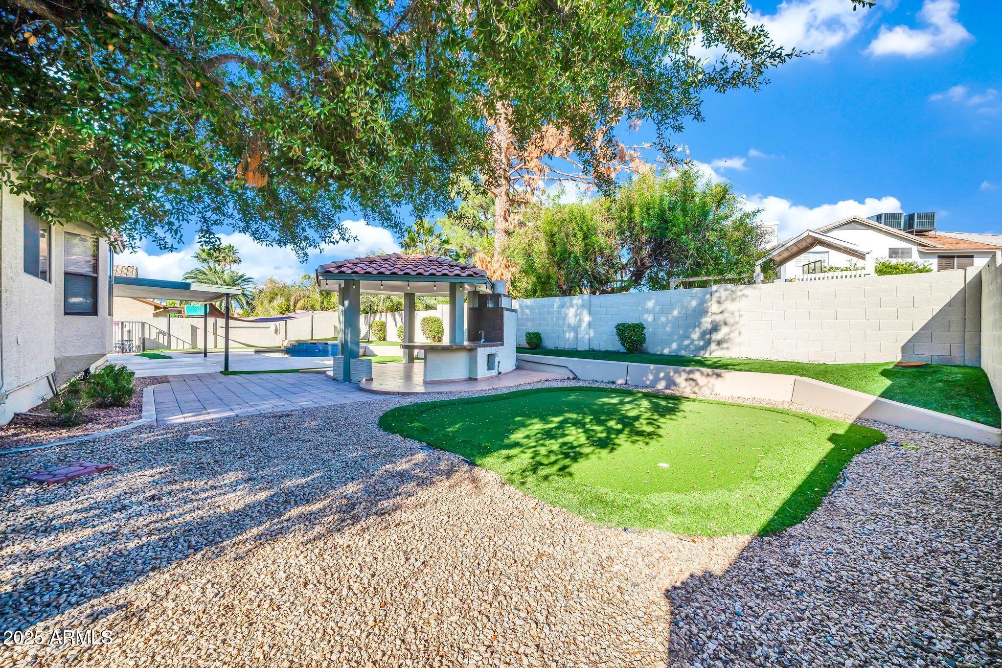 5044 East Paradise Lane Scottsdale, AZ 85254 - Photo 46 of 61 a view of a house with a yard and sitting area