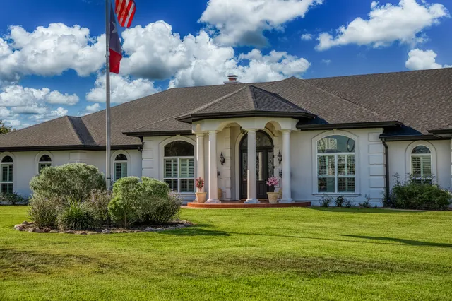 a front view of a house with a garden