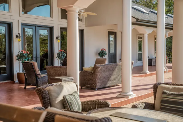 a view of a livingroom with furniture and floor to ceiling windows