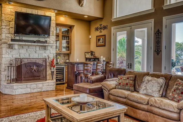 a living room with furniture fireplace and flat screen tv