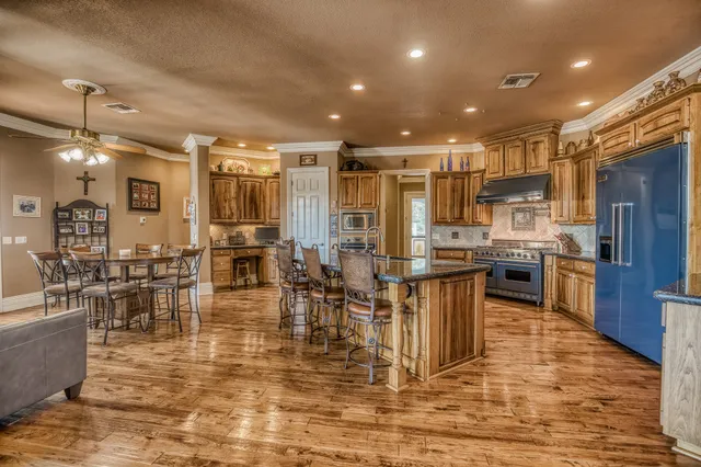 a room with lots of wooden furniture and appliances