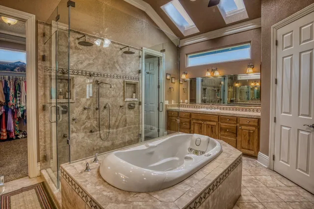 a bathroom with a granite countertop sink and mirror