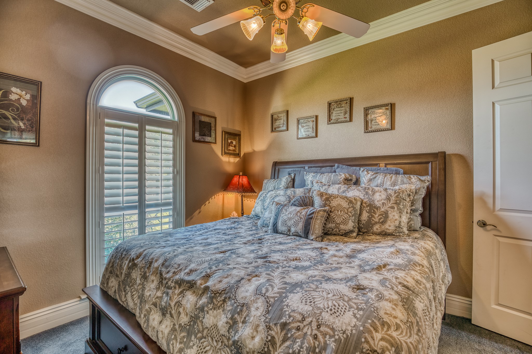 547 Powder Ridge Luling, TX 78648 - Photo 35 of 50 a bedroom with a large bed and a chandelier