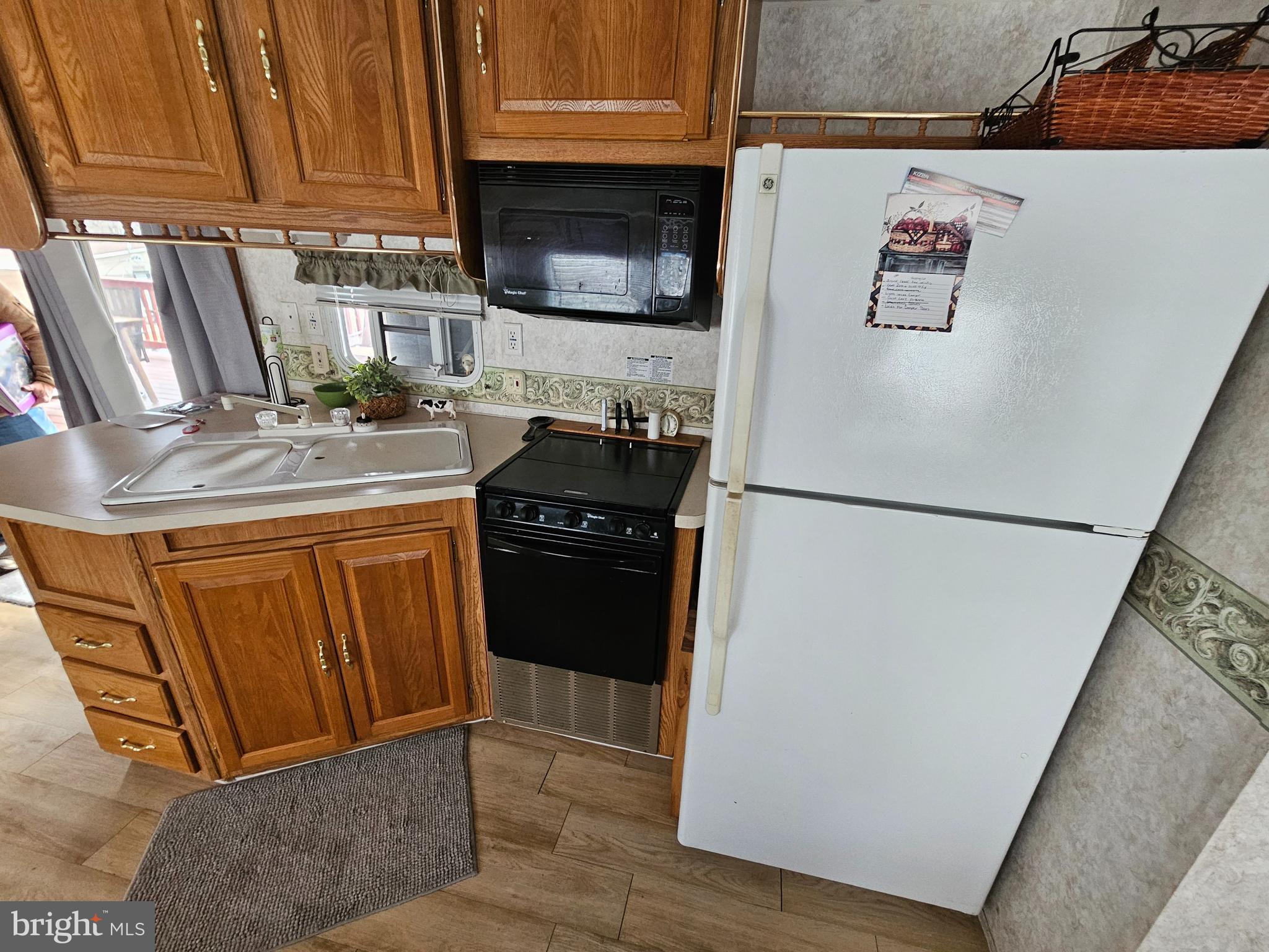 48 Hot Dog Road Falling Waters, WV 25419 - Photo 15 of 39 a kitchen with stainless steel appliances granite countertop a refrigerator a stove a sink and a microwave