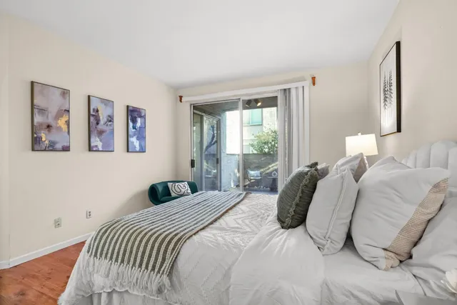 a bedroom with a bed and a night stand