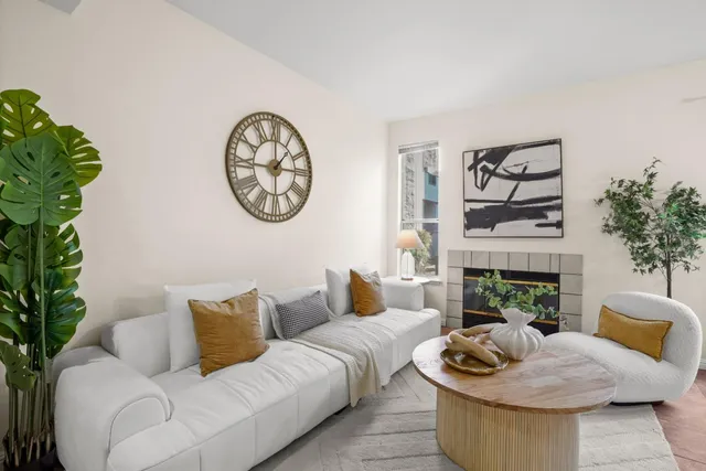 a living room with furniture and a fireplace