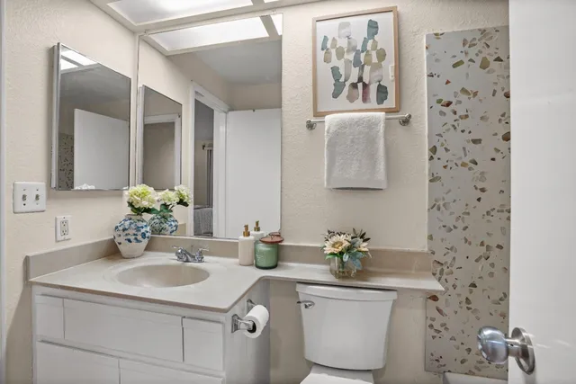 a bedroom with a bed and a potted plant