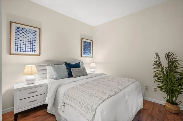 a bedroom with a bed and lamp