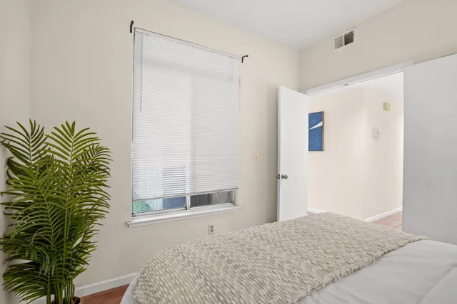 a view of a hallway to a livingroom with furniture and front door