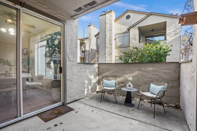 a view of a patio with table and chairs and potted plants