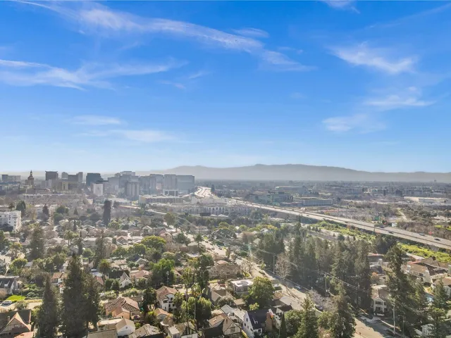 an aerial view of residential building and trees around