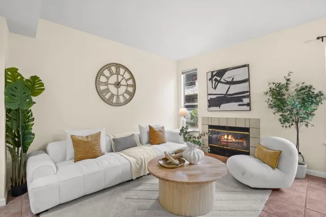 a living room with furniture and a fireplace