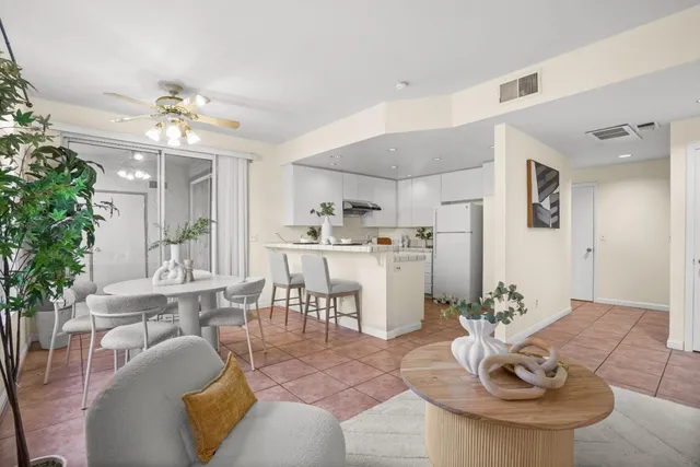 a living room with furniture potted plant and a chandelier