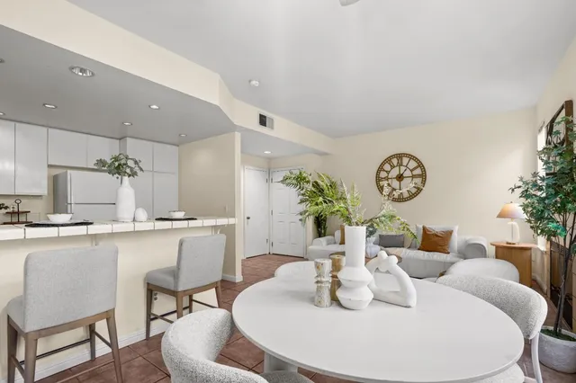 a dining room with furniture a table and a large window