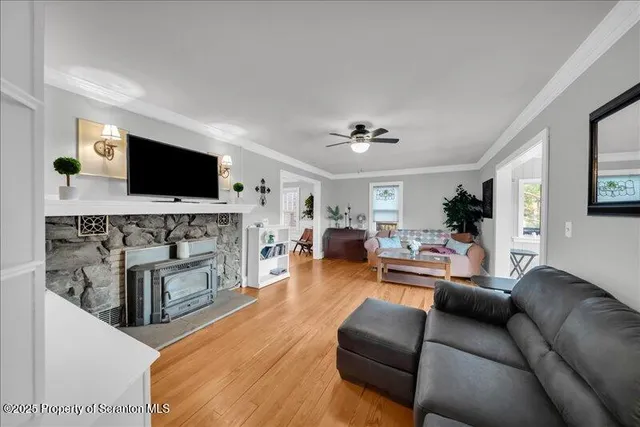 a living room with furniture a fireplace and a flat screen tv