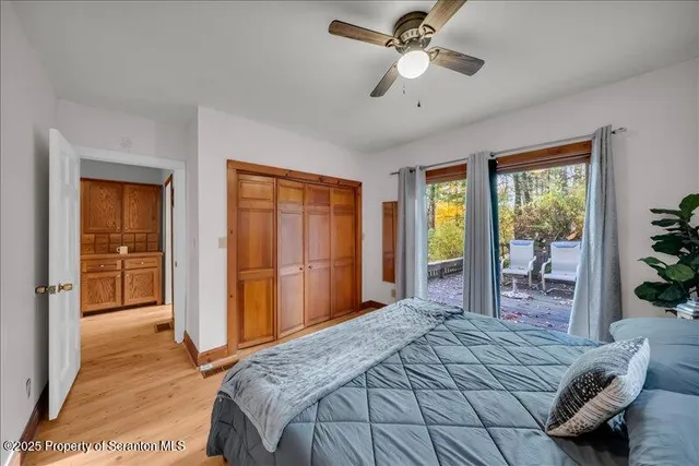 a bedroom with a bed and a large window