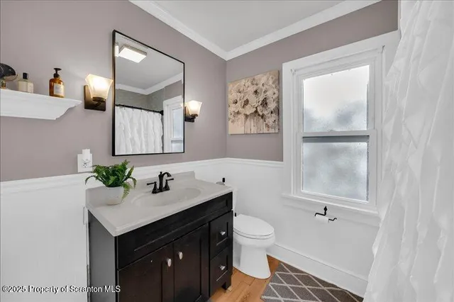 a bathroom with a sink vanity toilet and shower