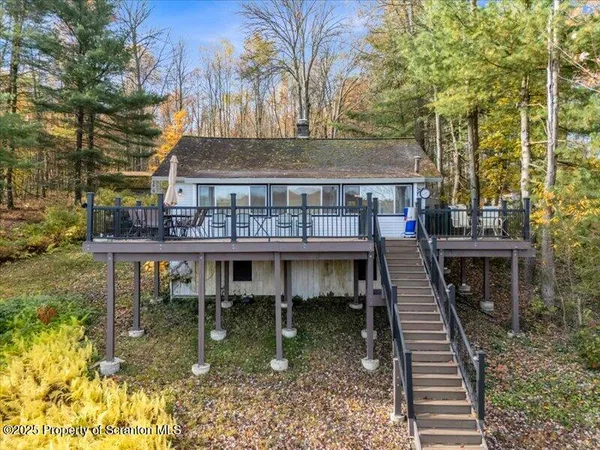a view of a house with backyard water fountain and sitting area