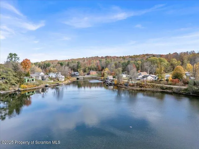 a view of residential houses with outdoor space and lake view