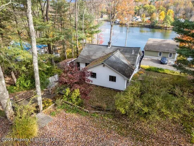 an aerial view of a house with a yard