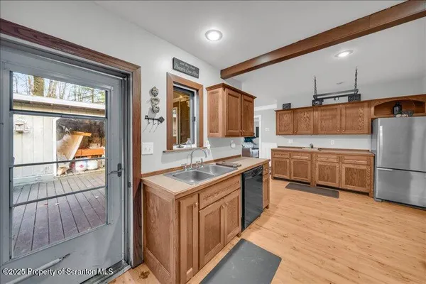 a kitchen with a sink refrigerator and cabinets