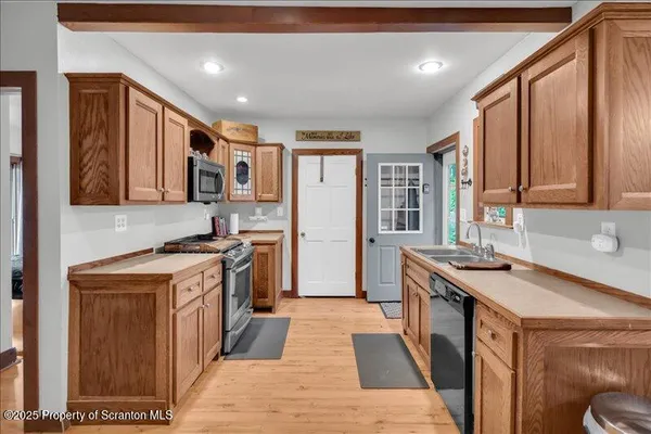 a kitchen with a sink stove and refrigerator