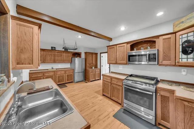 a kitchen with stainless steel appliances granite countertop a stove and a sink