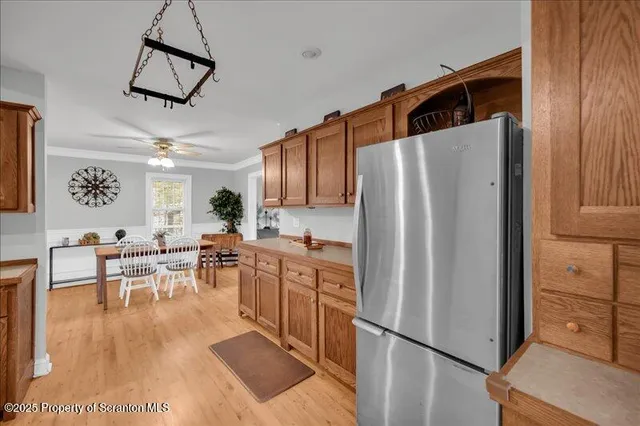 a kitchen with stainless steel appliances a refrigerator and microwave