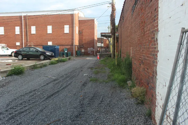 a view of a brick house next to a road