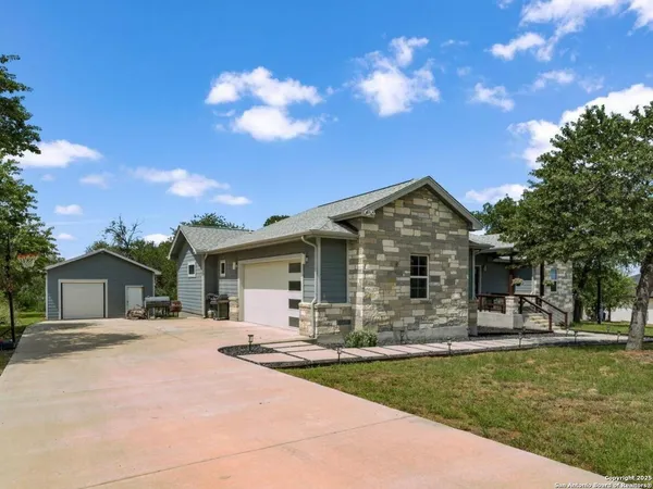 a front view of house with yard and green space