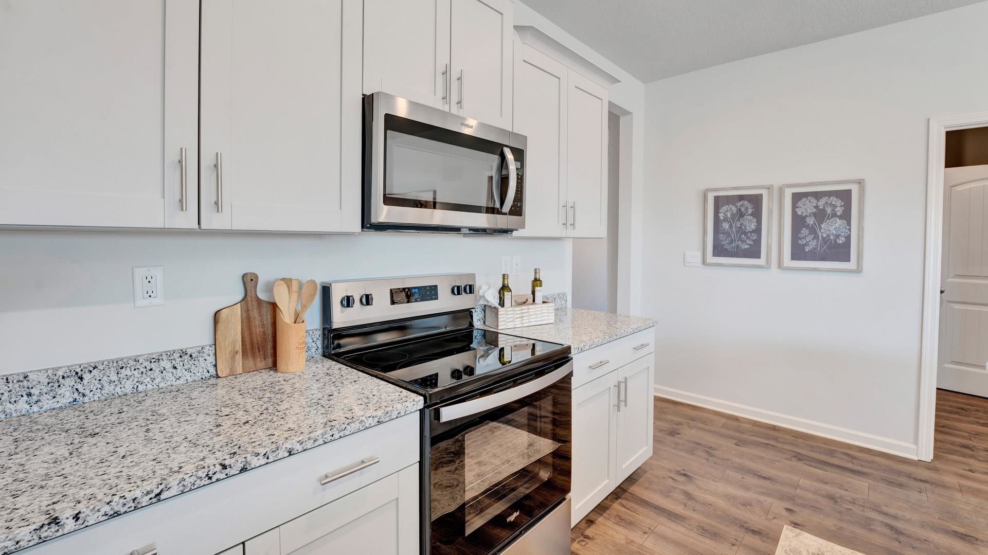1020 Mewborn Farm Road Oakland, TN 38060 - Photo 11 of 36 a kitchen with granite countertop a stove and a microwave